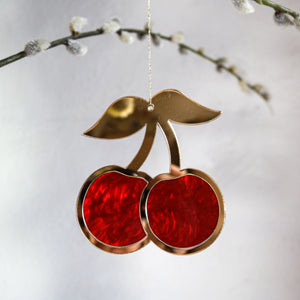 Red & gold cherry hanging ornament in tree