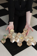 Load image into Gallery viewer, Rhombille tiling art decoration held against a checkered pattern floor
