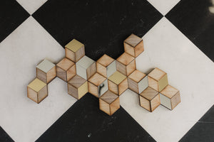 a Rhombille tiling wall decoration laid against a checkered floor
