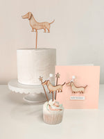 Load image into Gallery viewer, A sausage dog shaped cake topper and card gifting kit
