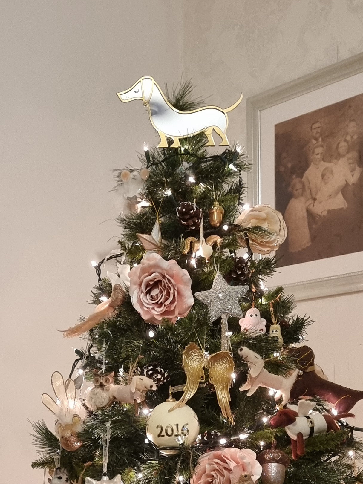 Sausage dog shaped christmas tree topper on christmas tree