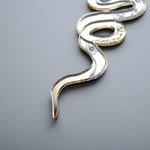 Load image into Gallery viewer, The tail of a snake shaped mirror ornament with etched flowers
