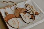 Load image into Gallery viewer, 3 woodland themed decorations in the shape of a leaf, acorn and mushroom made from wood in a gift box.
