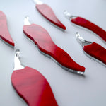 Load image into Gallery viewer, 6 chilli pepper ornaments laying flat on a table.
