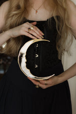 Load image into Gallery viewer, A gold and silver crescent moon mirror held in hands
