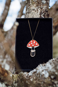 A red, white and silver toadstool shaped necklace with acrylic and mirror in a gift box.