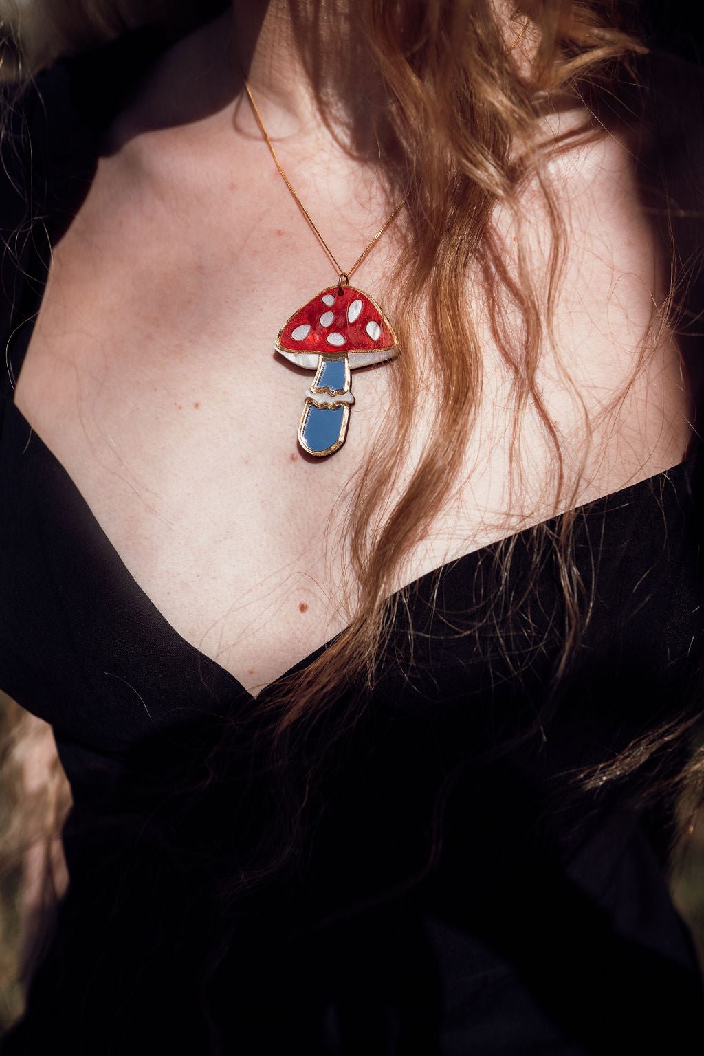 A magical mushroom shaped necklace with acrylic and mirror.