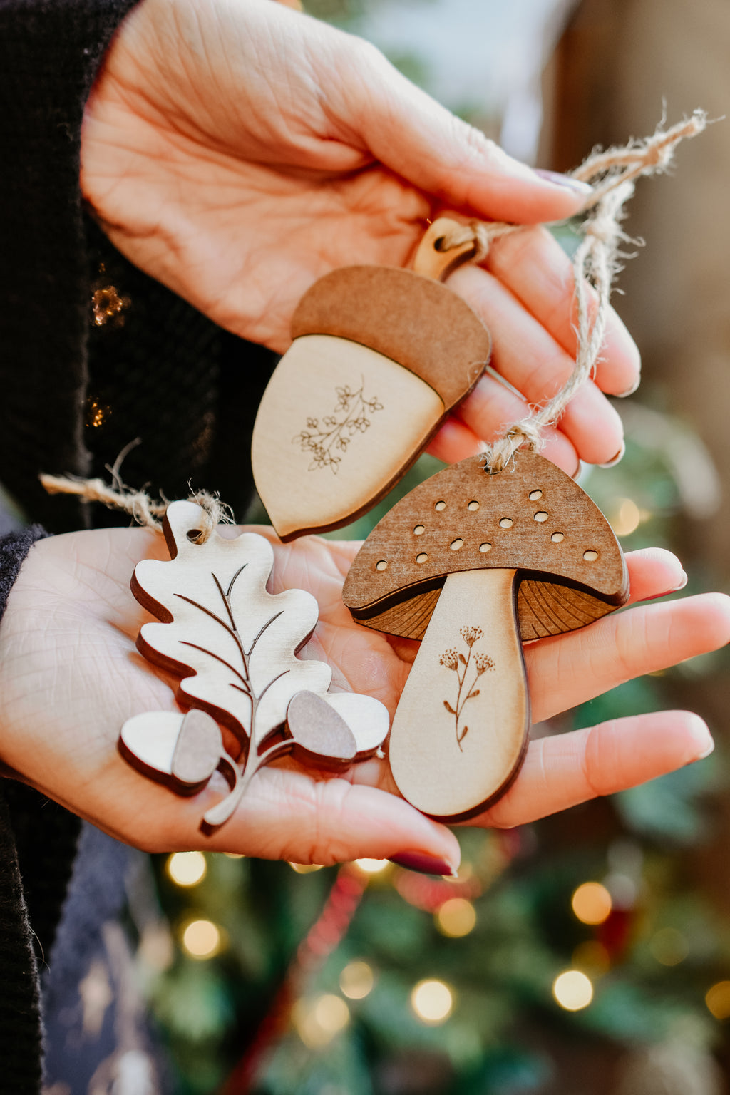 3 woodland themed decorations in the shape of a leaf, acorn and toadstool made from wood.