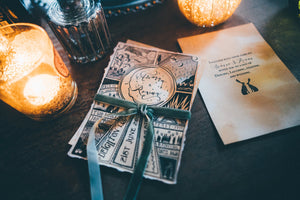 Black illustrated wedding invitation with candles