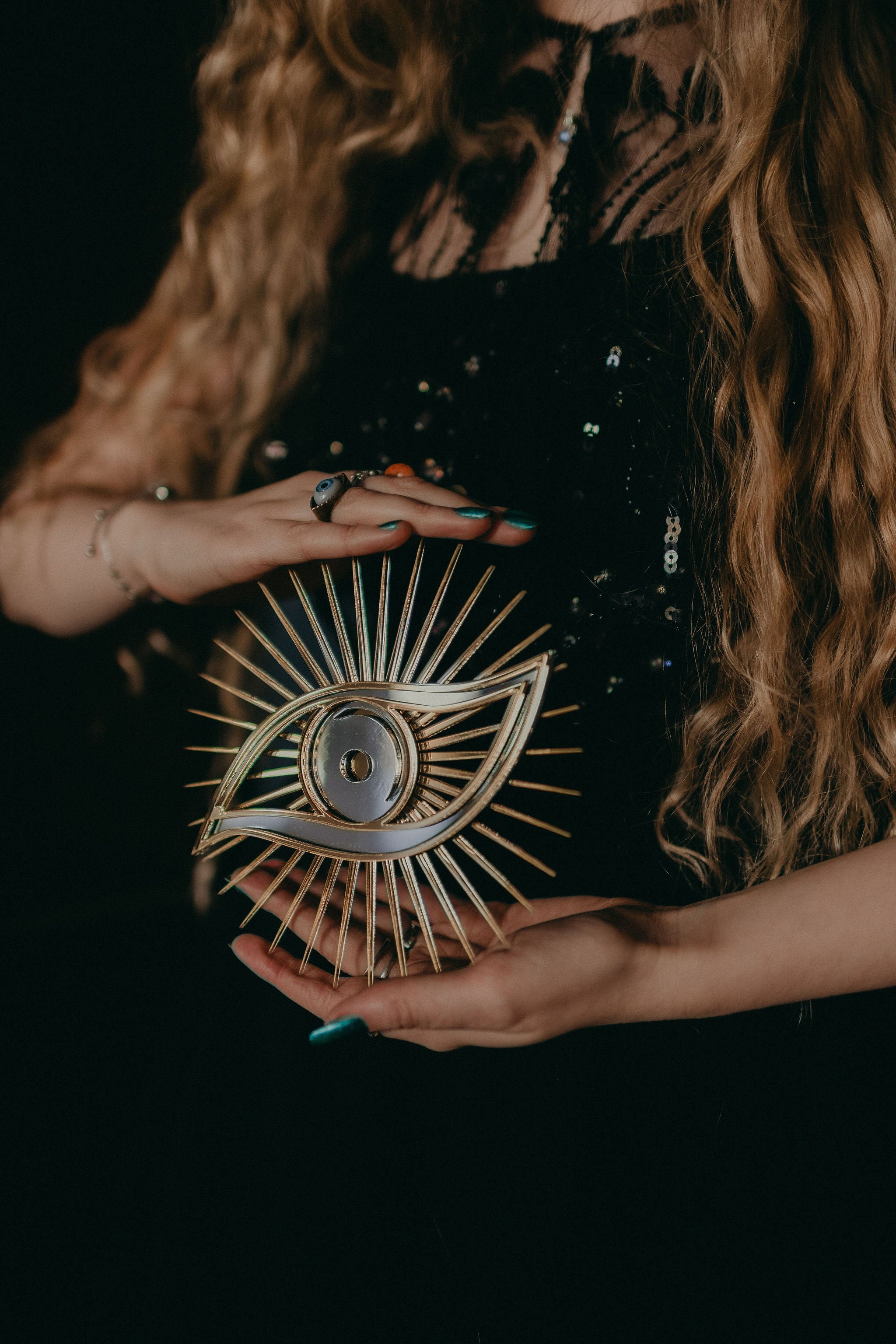 All seeing eye shaped christmas tree topper held in hands.