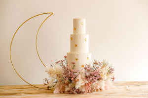 Star cake charms on 3 tiered wedding cake with crescent moon display