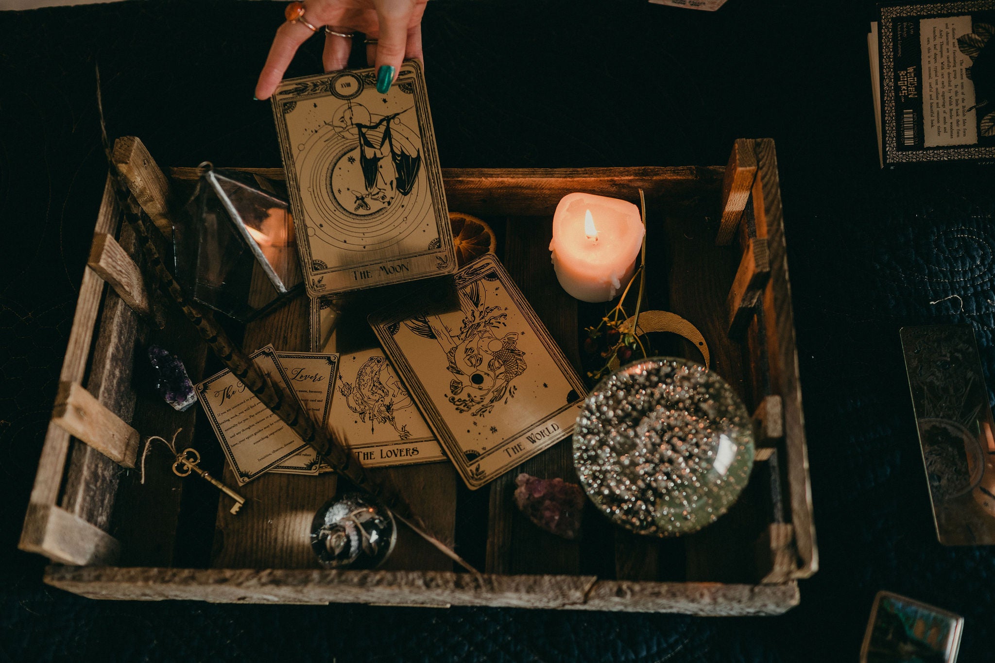 Three decorative tarot cards with a bat hanging under the moon, the lovers and the world.