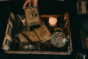 Three decorative tarot cards with a bat hanging under the moon, the lovers and the world.