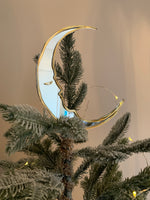 Load image into Gallery viewer, A crescent moon shaped christmas tree topper on the top of a christmas tree.
