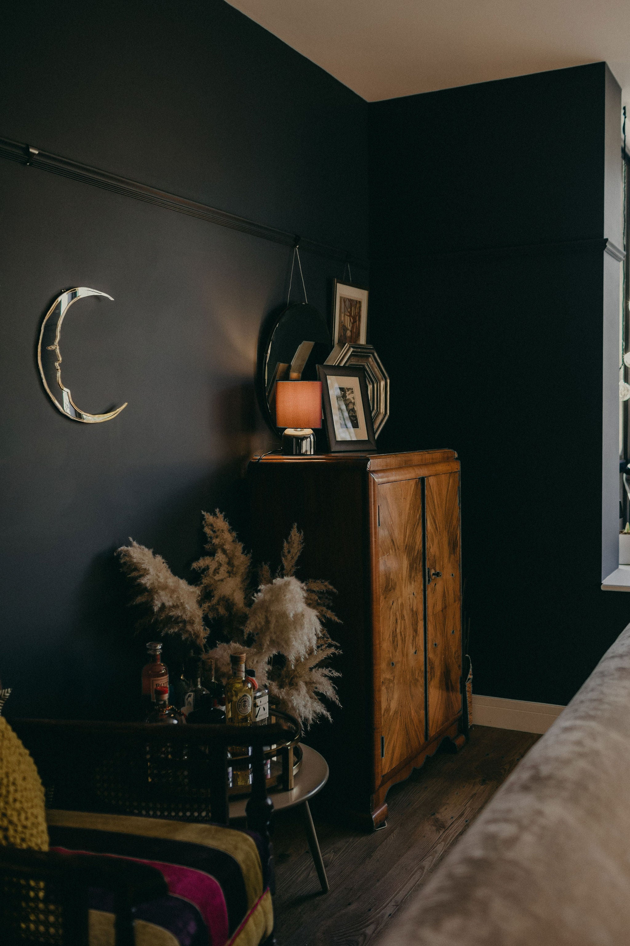 crescent moon shaped mirror on the wall of a home.