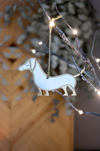 Gold and silver mirrored sausage dog ornament.