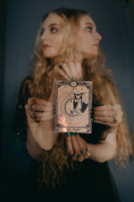 Load image into Gallery viewer, A decorative tarot card with a bat hanging under the moon.

