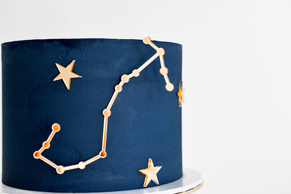 zodiac blue birthday cake with constellation charms 