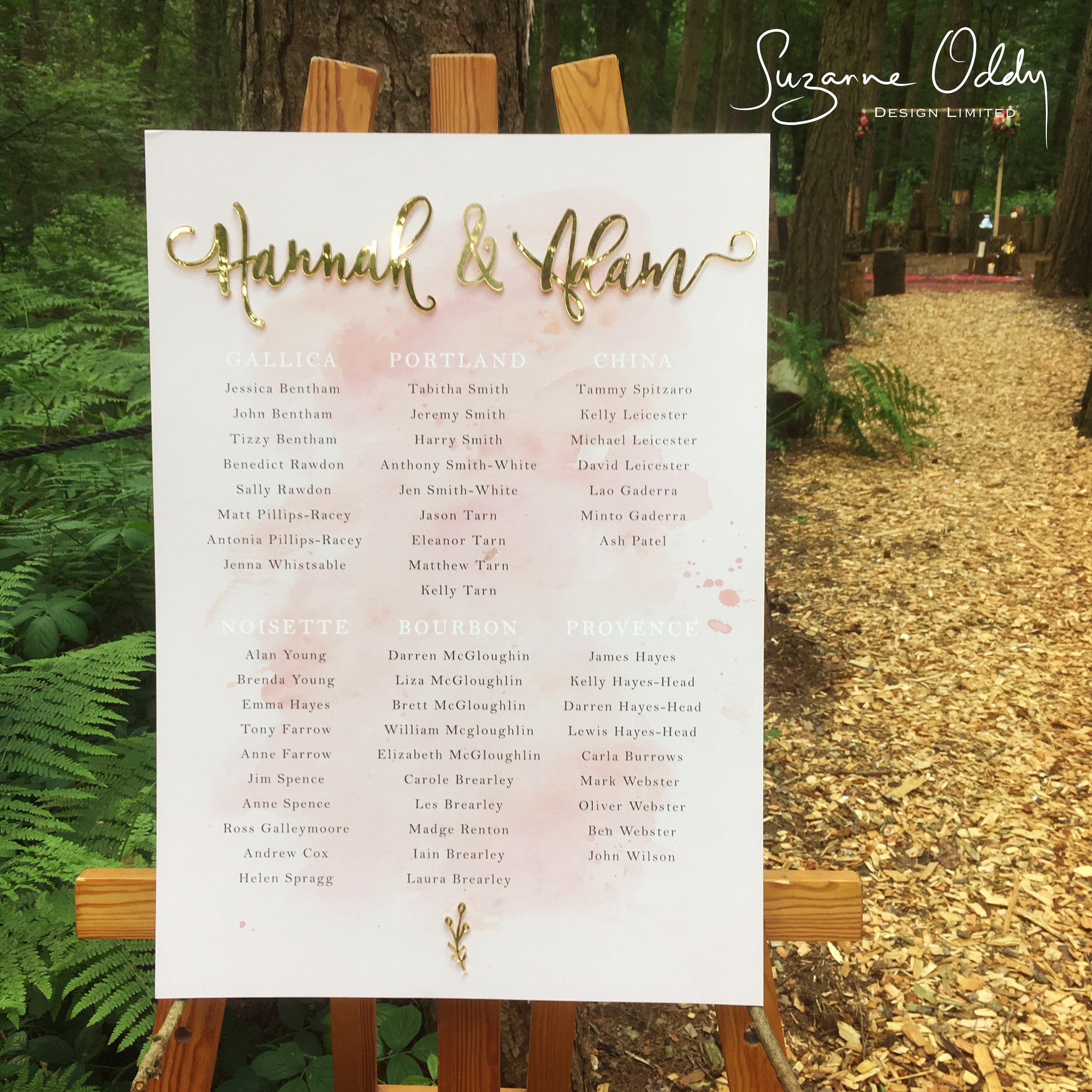 Blush pink seating plan with gold names in outdoor wedding