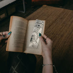 Load image into Gallery viewer, Mystical Eye and Lion Bookmark inside book
