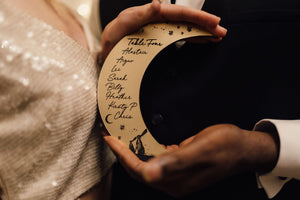 Crescent moon shaped table seating plan for celestial wedding with etched names & rabbits.