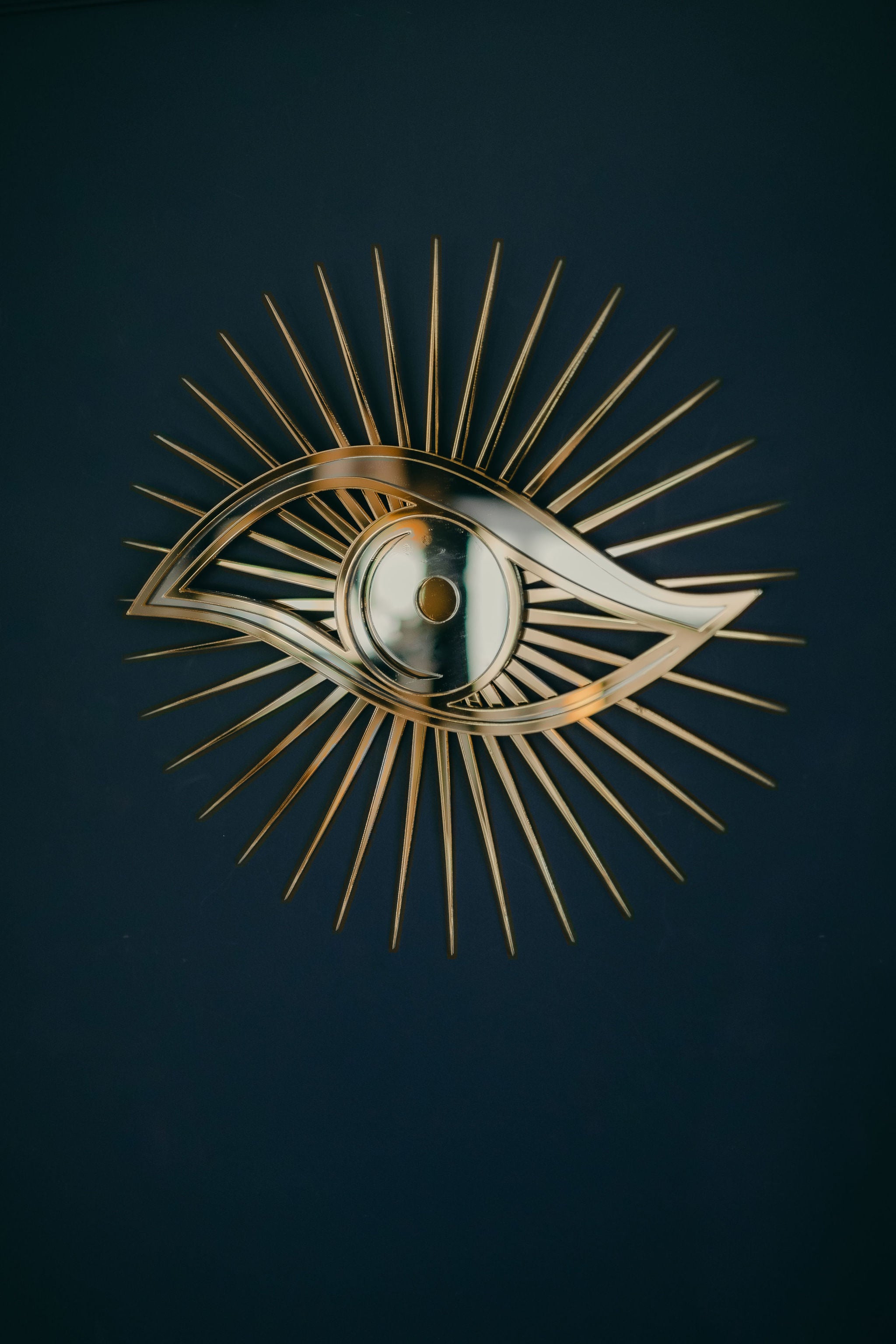Gold All seeing eye shaped mirror.