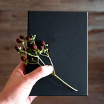 Load image into Gallery viewer, A black gift box with flowers.
