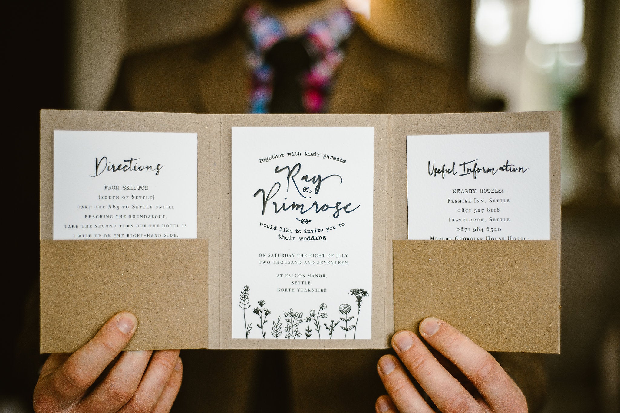 A floral rustic wedding invitation in pocket fold