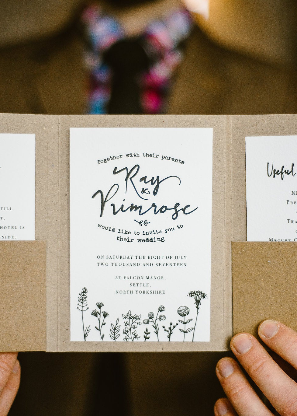 A floral rustic wedding invitation in pocket fold