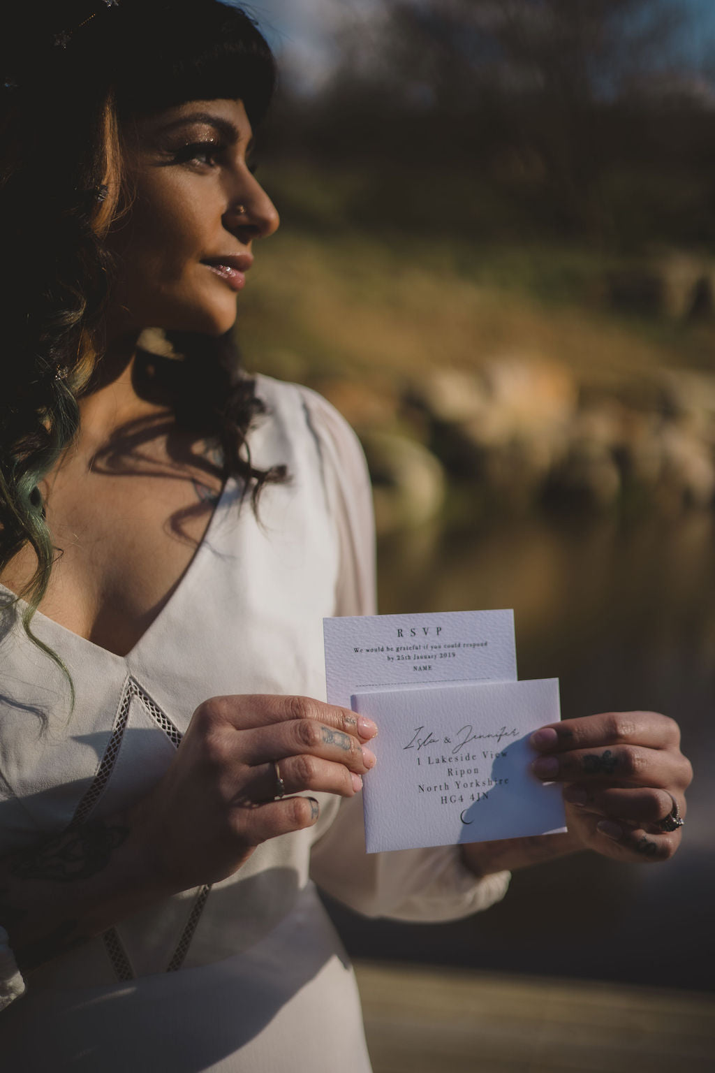 A woman holding a celestial inspired wedding RSVP