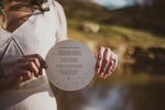 Load image into Gallery viewer, A circular wedding invitation with celestial designs
