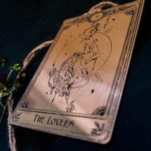 The Lovers decorative tarot card with etched design of mouse and frog in the moonlight.