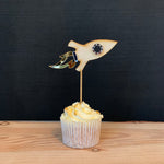 Load image into Gallery viewer, wooden rocket shaped cake topper on a cupcake.
