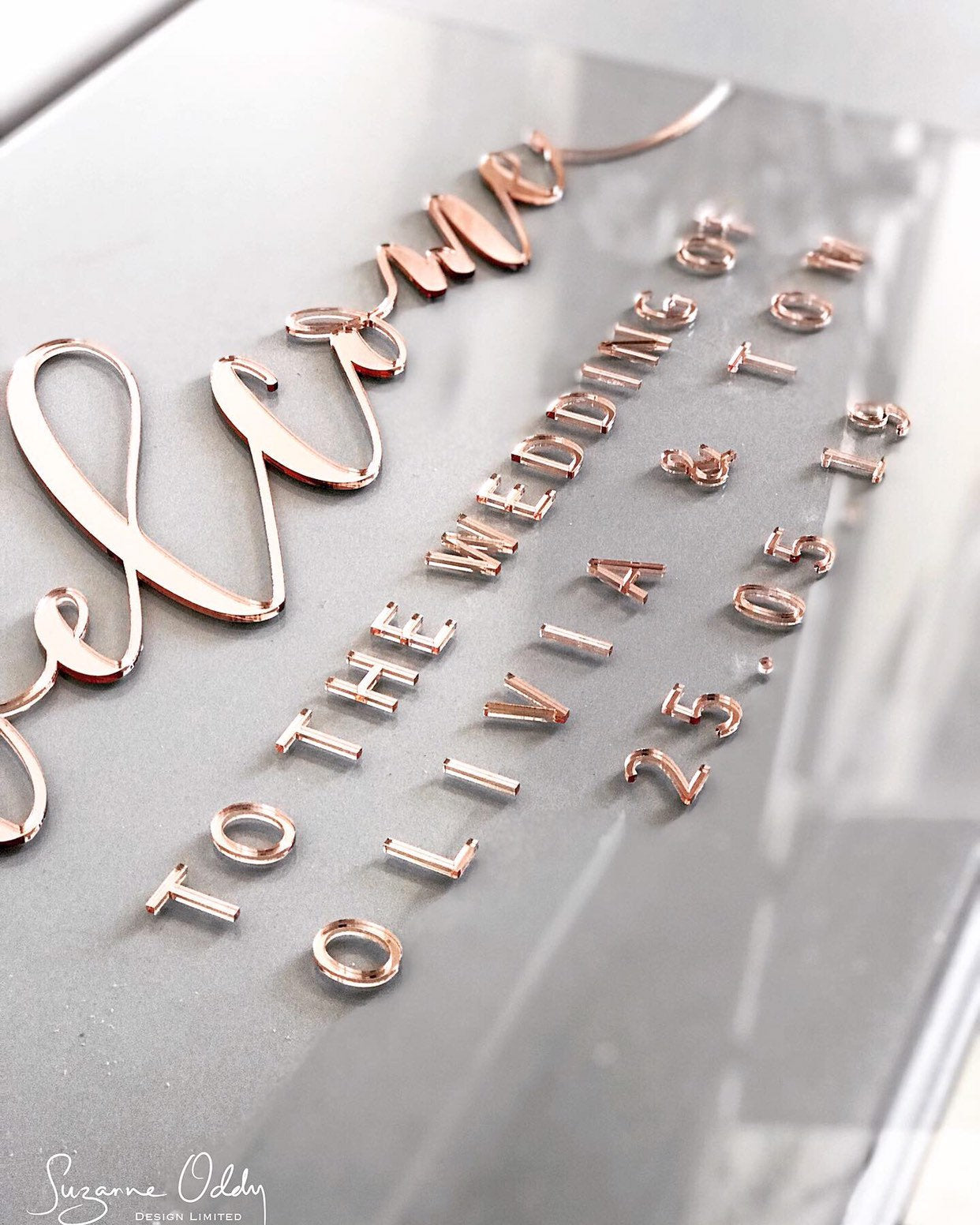 Clear acrylic wedding sign with welcome to the wedding in rose gold