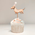 Load image into Gallery viewer, A sausage dog shaped cupcake topper on a cupcake
