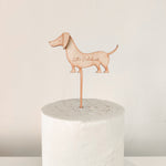 Load image into Gallery viewer, A wooden engraved sausage dog shaped cake topper
