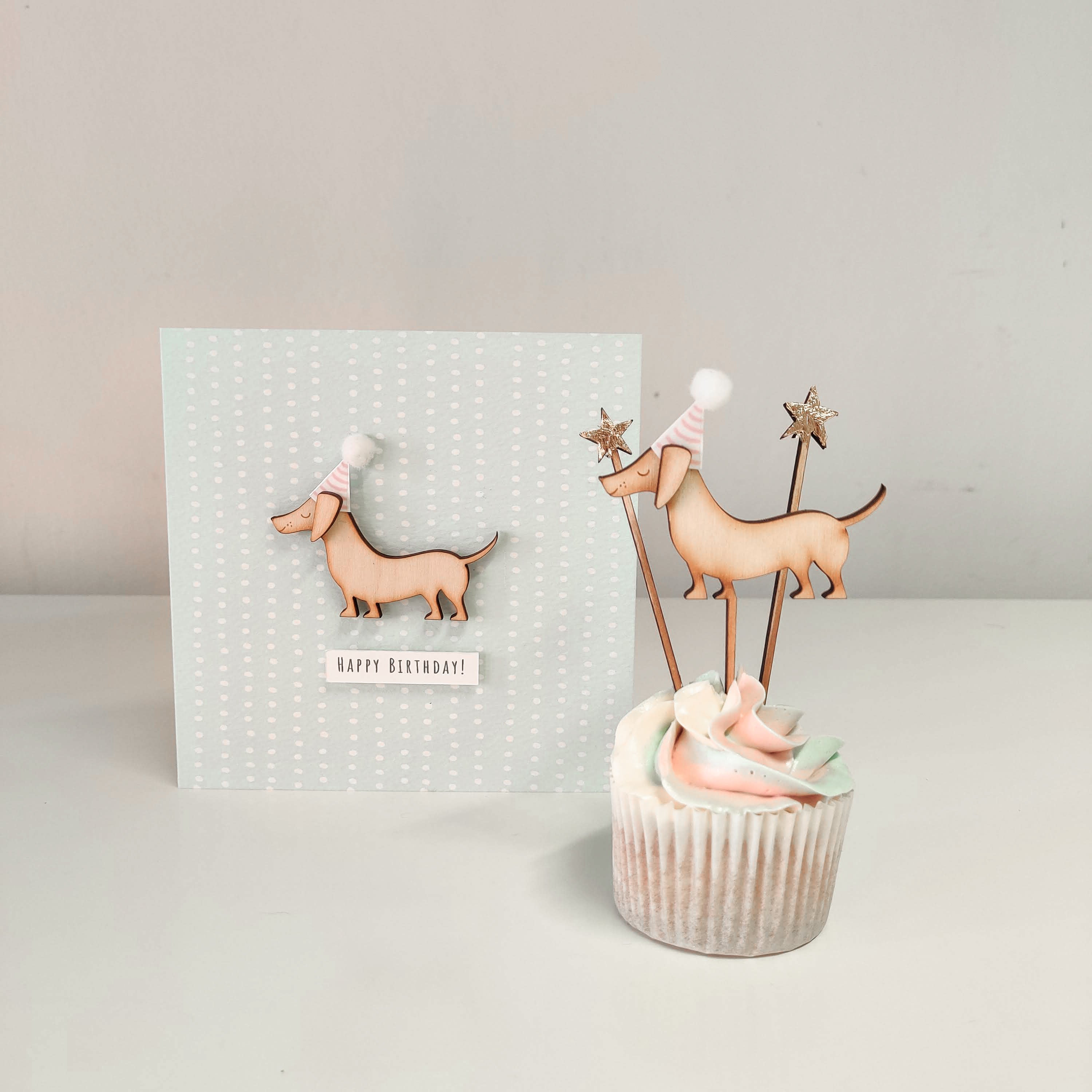 A wooden sausage dog cupcake topper and birthday card with wooden decal