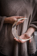 Load image into Gallery viewer, a person holding a small crescent moon shaped mirror.
