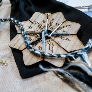 Wooden knitting circle engraved with a celestial sun design with wool and keepsake velvet bag.