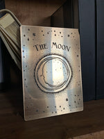 Load image into Gallery viewer, A gold decorative tarot card with etched design of a crescent moon, stars and the words &#39;the moon&#39;
