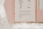 Load image into Gallery viewer, A ripped edge wedding invitation with floral design and pink envelope
