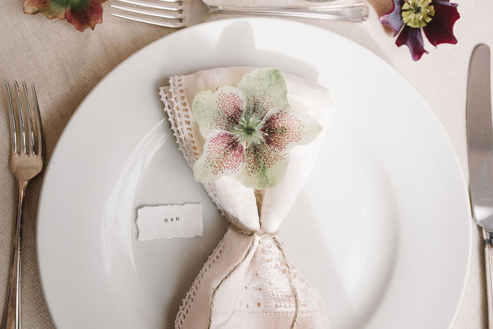 torn edge place name card with napkin and cutlery