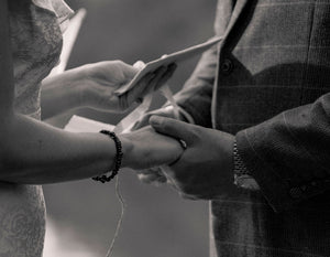 hands holding vow book at elopement ceremony