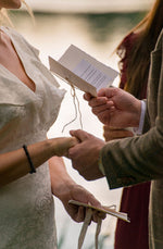 Load image into Gallery viewer, A handcrafted vow book with string decorations held in hands
