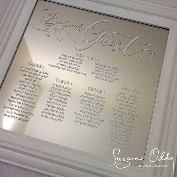 A white themed mirror style wedding seating plan