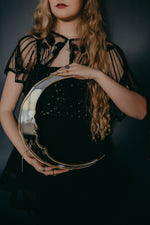 Load image into Gallery viewer, crescent moon shaped mirror held in hands.
